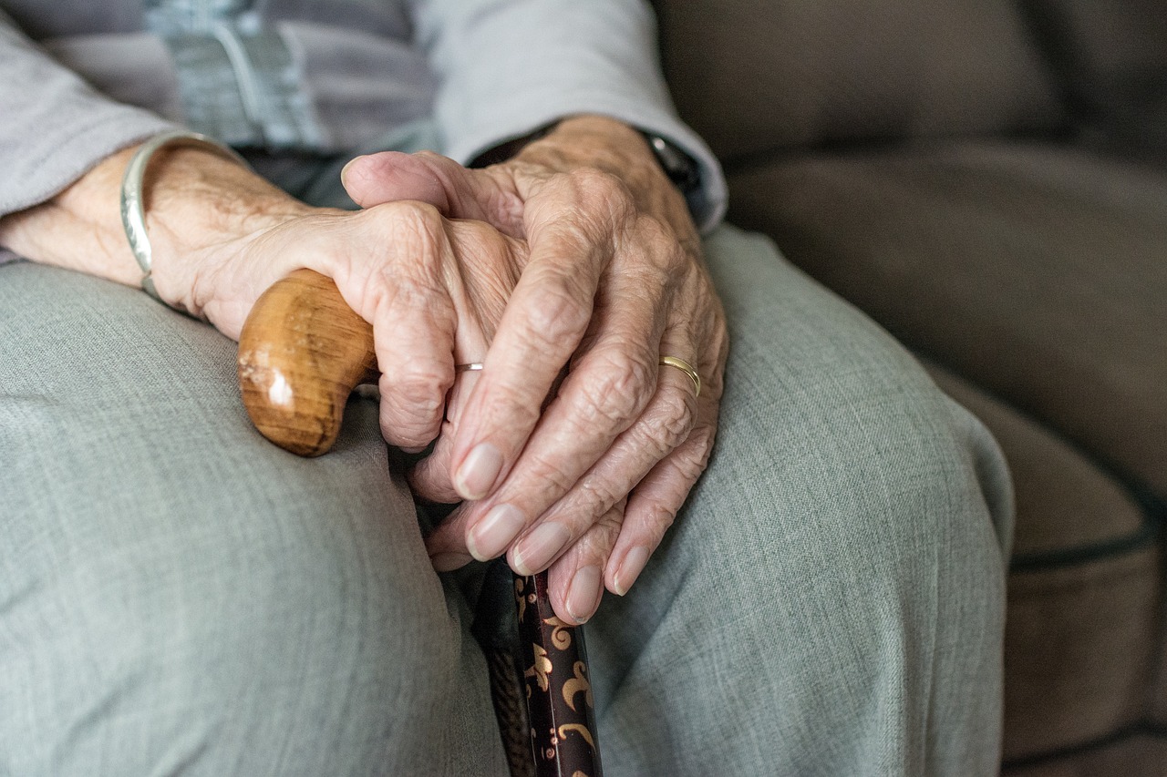 Gros plan sur les mains d'une femme âgée qui tient une canne